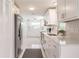 Renovated kitchen features white cabinets, stainless appliances, and long countertops at 444 Edgewood Rd, Venice, FL 34293