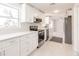 Clean kitchen with white cabinets and countertops with stainless steel appliances at 444 Edgewood Rd, Venice, FL 34293