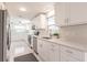 Bright kitchen featuring white cabinetry, stainless steel appliances, and quartz countertops at 444 Edgewood Rd, Venice, FL 34293