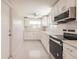 Bright kitchen features white cabinetry, stainless steel appliances, and recessed lighting at 444 Edgewood Rd, Venice, FL 34293