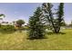 Waterfront backyard with mature trees overlooking a tranquil waterway at 444 Edgewood Rd, Venice, FL 34293