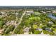 Overhead view of the home with a pool, outbuildings, green space, and partial privacy fence at 4511 Wilkinson Rd, Sarasota, FL 34233