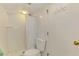 Tiled bathroom features a standard toilet and shower with shower curtain at 4511 Wilkinson Rd, Sarasota, FL 34233