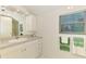 Well-lit bathroom features a single sink vanity with cabinet and drawer storage at 4511 Wilkinson Rd, Sarasota, FL 34233