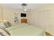Serene bedroom features two beds, a ceiling fan, and a private bathroom in the background at 4511 Wilkinson Rd, Sarasota, FL 34233