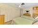 Bright bedroom featuring two beds, ceiling fan, and a closet with mirrored doors at 4511 Wilkinson Rd, Sarasota, FL 34233