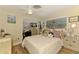 Bright bedroom features a ceiling fan and windows for natural light at 4511 Wilkinson Rd, Sarasota, FL 34233
