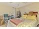 Bright bedroom featuring a comfortable bed, ample storage, and a ceiling fan at 4511 Wilkinson Rd, Sarasota, FL 34233