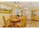 Bright dining area showcasing a wood table and chairs, chandelier, and tile flooring at 4511 Wilkinson Rd, Sarasota, FL 34233