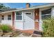 Charming front door with white trim, red brick, and stylish accents at 4511 Wilkinson Rd, Sarasota, FL 34233