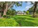 Charming single story home with lush green lawn and mature trees providing ample shade at 4511 Wilkinson Rd, Sarasota, FL 34233