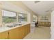 Bright kitchen with plentiful counter space and adjacent living area at 4511 Wilkinson Rd, Sarasota, FL 34233
