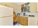 Functional kitchen featuring a vintage refrigerator, painted wall art, and ample counter space at 4511 Wilkinson Rd, Sarasota, FL 34233
