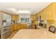 Well-lit kitchen with wood cabinets, stainless steel appliances, and modern countertops at 4511 Wilkinson Rd, Sarasota, FL 34233
