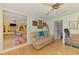 Relaxing living room showing hardwood floors, with a sofa, ceiling fan, and open doorway at 4511 Wilkinson Rd, Sarasota, FL 34233