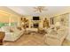 Comfortable living room featuring a fireplace, tile flooring, plush sofas, and built-in shelving, creating a cozy space at 4511 Wilkinson Rd, Sarasota, FL 34233