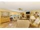 Bright living room features tile floors, a fireplace, ample natural light, and a comfortable seating area at 4511 Wilkinson Rd, Sarasota, FL 34233