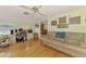 Cozy living space with hardwood floors, a ceiling fan, and a comfortable seating arrangement at 4511 Wilkinson Rd, Sarasota, FL 34233