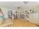 Inviting living area with hardwood floors, built-in shelving, and a comfortable seating area at 4511 Wilkinson Rd, Sarasota, FL 34233