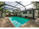 Screened-in pool area with hot tub, seating, and outdoor entertaining space at 4511 Wilkinson Rd, Sarasota, FL 34233