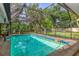 Large screened pool area with seating and lush landscaping at 4511 Wilkinson Rd, Sarasota, FL 34233