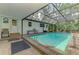 Screened-in pool area featuring a sparkling pool, with ample seating, and a covered space for relaxing at 4511 Wilkinson Rd, Sarasota, FL 34233