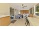 Bright sunroom with a ceiling fan, a washer & dryer, and lots of natural light at 4511 Wilkinson Rd, Sarasota, FL 34233