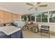 Bright sunroom featuring lots of windows, natural light, and a ceiling fan at 4511 Wilkinson Rd, Sarasota, FL 34233