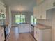 Bright kitchen with granite countertops, stainless steel appliances, and shaker style white cabinets at 10023 Greetings St, Port Charlotte, FL 33981