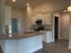 Modern kitchen with white cabinetry, granite countertops, and stainless steel appliances at 10023 Greetings St, Port Charlotte, FL 33981