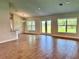 Bright living room with wood-look tile flooring and views to the outdoors through large windows at 10023 Greetings St, Port Charlotte, FL 33981