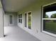 Covered outdoor patio offers a relaxing space with a view to the backyard, accessible through glass doors at 10023 Greetings St, Port Charlotte, FL 33981