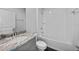 Bright bathroom featuring a granite-topped vanity and shower-over-tub with a white subway tile surround at 1057 Presque Isle Dr, Port Charlotte, FL 33952