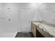 Bathroom with shower, vanity with granite countertop and wood cabinets, and large mirror at 1057 Presque Isle Dr, Port Charlotte, FL 33952