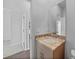 Neutral bathroom featuring a granite-topped vanity, mirror, and views of adjacent rooms at 1057 Presque Isle Dr, Port Charlotte, FL 33952