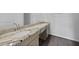 Bathroom vanity featuring a granite countertop and wood cabinets at 1057 Presque Isle Dr, Port Charlotte, FL 33952
