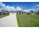Charming single-story home with a well-manicured lawn, front-facing garage, and stone details at 1057 Presque Isle Dr, Port Charlotte, FL 33952