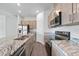Close-up of kitchen with stainless steel appliances, granite countertops, and wood cabinetry at 1057 Presque Isle Dr, Port Charlotte, FL 33952