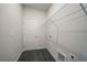 Utility room includes hookups, wire shelving, door, and hard surface floor at 1057 Presque Isle Dr, Port Charlotte, FL 33952