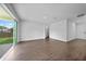 Spacious living room featuring wood flooring, neutral walls, and sliding glass doors at 1057 Presque Isle Dr, Port Charlotte, FL 33952