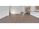 A spacious living area with stylish wood flooring and an open layout to the kitchen at 1057 Presque Isle Dr, Port Charlotte, FL 33952