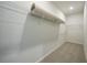 Walk-in closet featuring carpet, shelving and storage for organized convenience at 1057 Presque Isle Dr, Port Charlotte, FL 33952