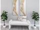 Inviting sitting area with artwork, bench, and lush plants creating a serene and stylish space at 12123 Platano Dr, Punta Gorda, FL 33955