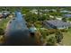 Waterfront home featuring lush landscaping, a private dock, and direct access to the serene canal at 13471 Chenille Dr, Port Charlotte, FL 33981