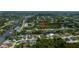 Aerial view of a waterfront community with lush landscaping and private canals at 13471 Chenille Dr, Port Charlotte, FL 33981