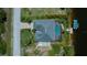 Overhead view of a home's layout with a pool, boat lift, and lush greenery at 13471 Chenille Dr, Port Charlotte, FL 33981