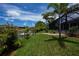 Lush backyard featuring a waterfront view and direct access to the canal at 13471 Chenille Dr, Port Charlotte, FL 33981