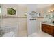 Elegant bathroom showcasing a walk-in shower with decorative tiles and a stylish vanity area at 13471 Chenille Dr, Port Charlotte, FL 33981