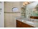 Modern bathroom with a spacious walk-in shower, wood cabinetry, and ample counter space at 13471 Chenille Dr, Port Charlotte, FL 33981
