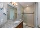 Bathroom featuring tiled shower with glass door, granite countertop, and a door to the pool area at 13471 Chenille Dr, Port Charlotte, FL 33981